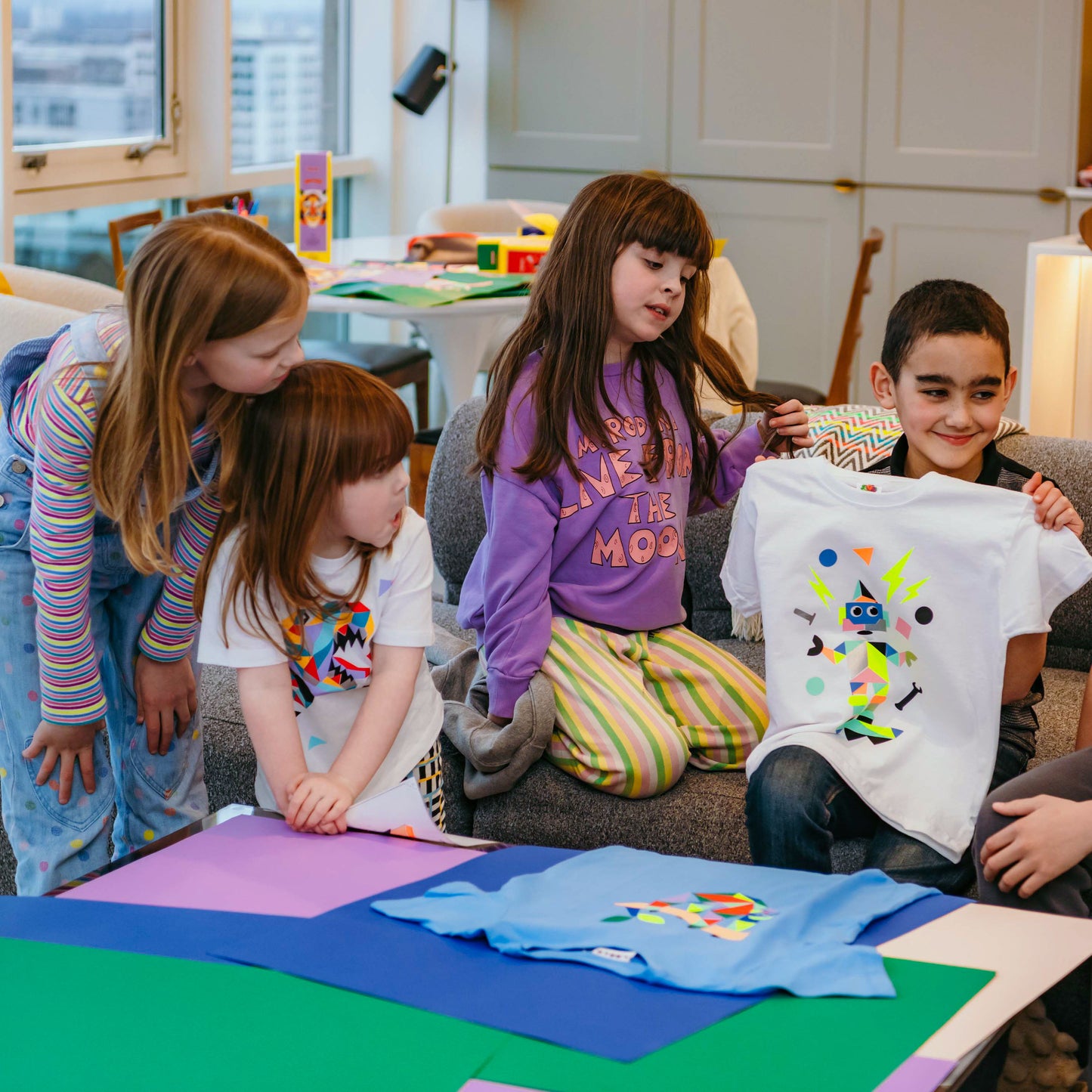 Kids making colorful prints on tote bags in a fun indoor craft session