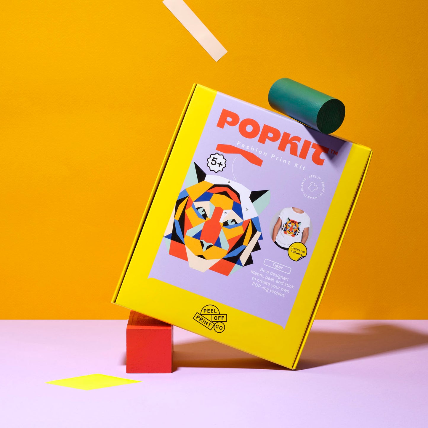 Yellow kids craft kit box with colorful tiger design on pink background