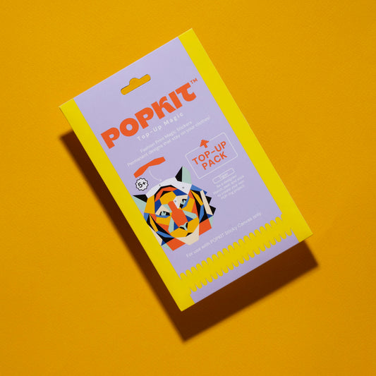 Yellow Popkit box with colorful unicorn design on orange background